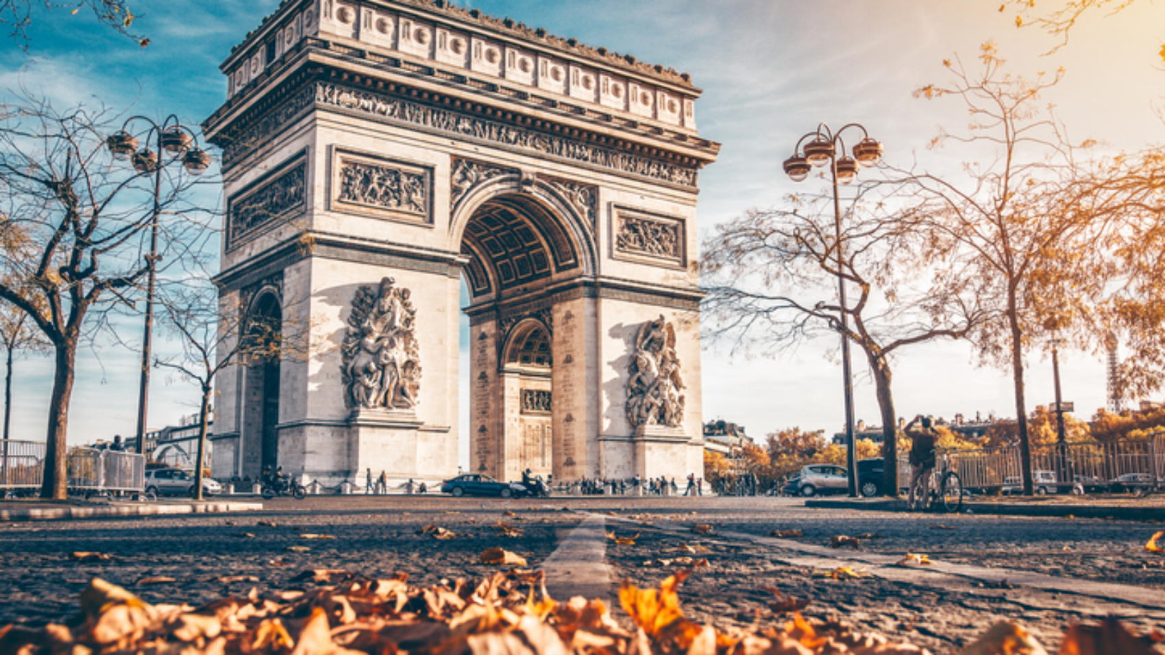 Arc de Triomphe located in Paris, in autumn scenery.